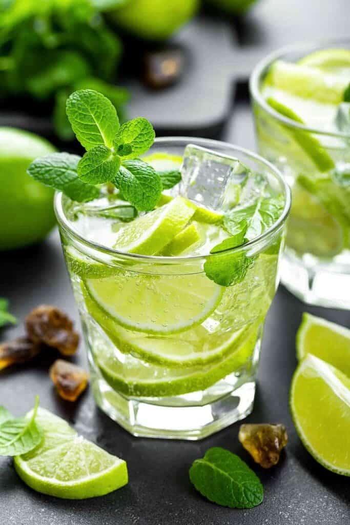 a glass of fresh Mexican Mojito served with fresh mint leaves on top and lime leaves