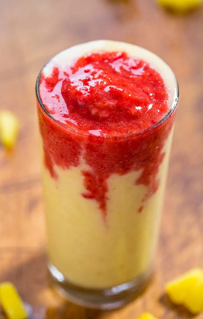 a glass of strawberry pineapple and banana lava flow smoothie