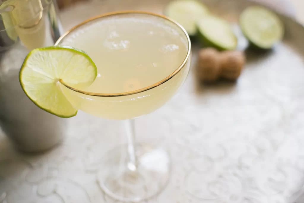 a mini glass of Lime Kissed Coconut Daiquiri serve with lime slice