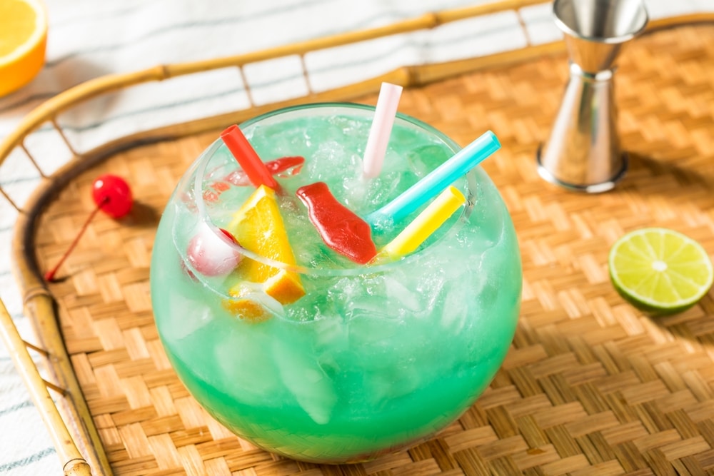 Boozy Cold Blue Tiki Fishbowl Cocktail With Orange And Rum