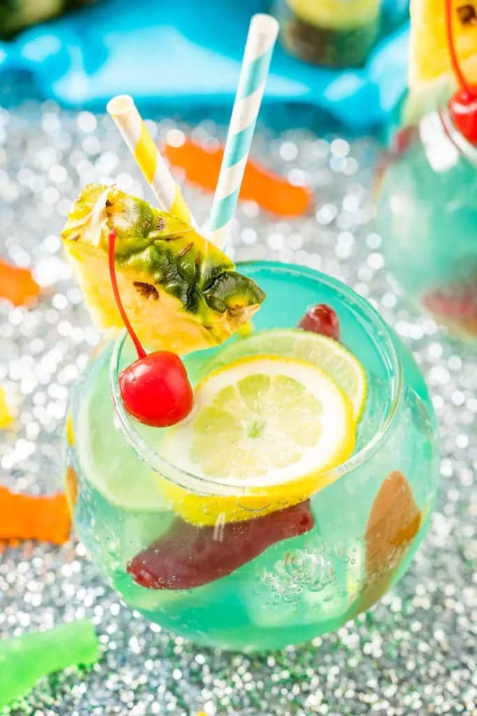 fish bowl drink along with the colorful straws and top with the lemon wedgespineapple chunk and red fresh cherry