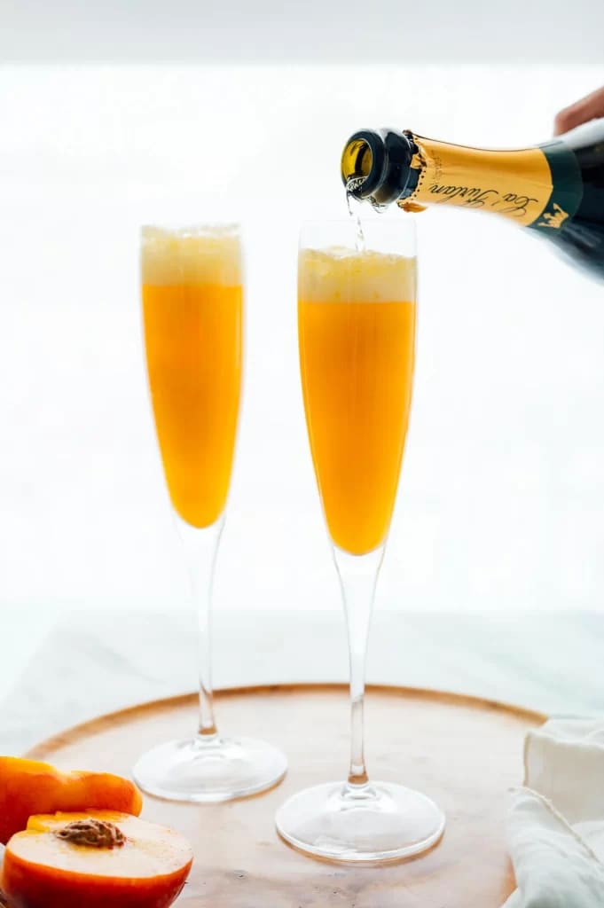 fresh bellini cocktail along with sliced peach