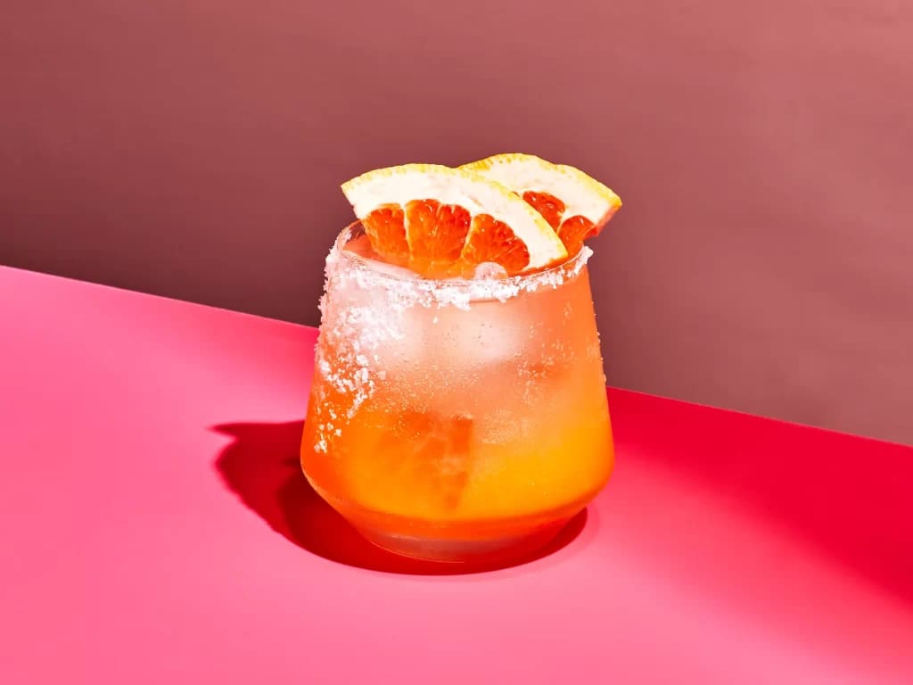 paloma cocktail served with fresh orange on top