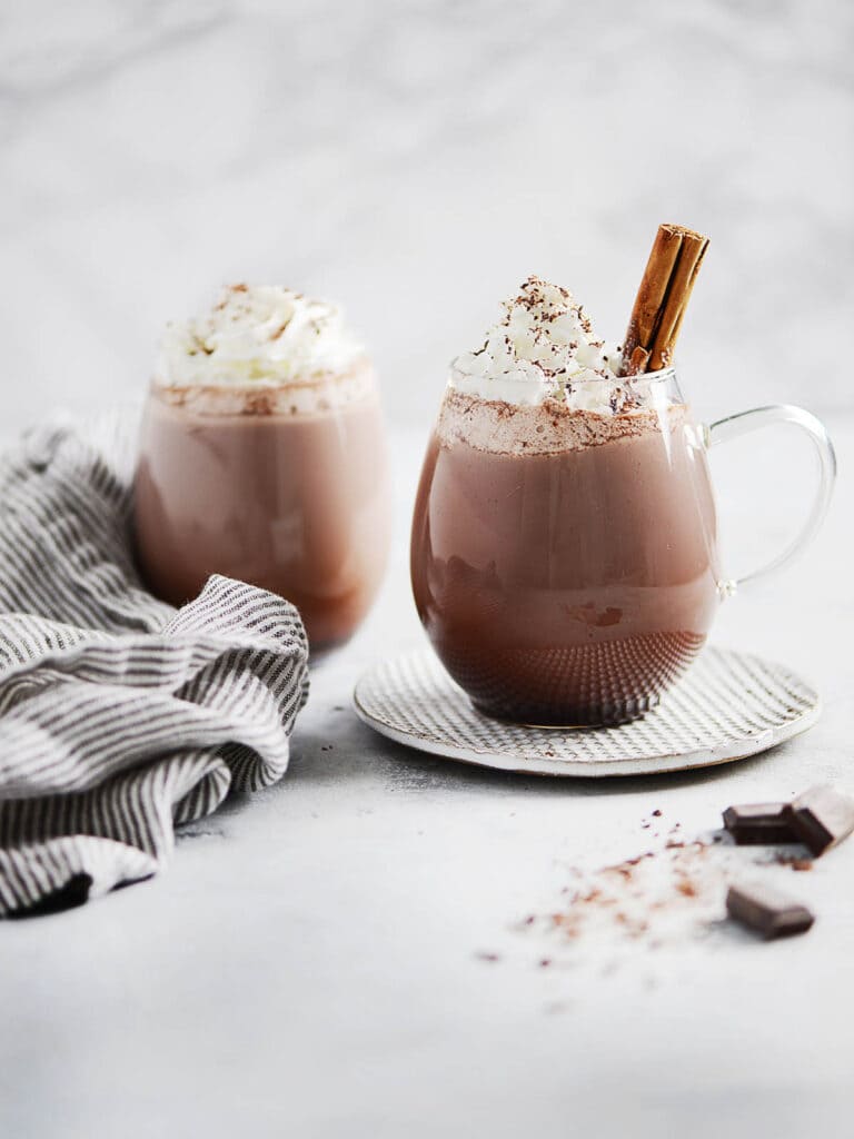 two glasses of mexican hot chocolate garnish with whipped cream