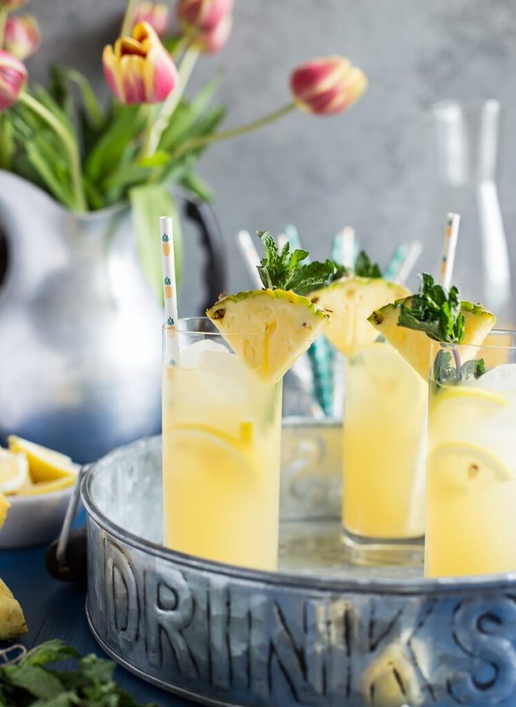 Pineapple Vanilla Bean Martini served in glasses with a pineapple slice at top