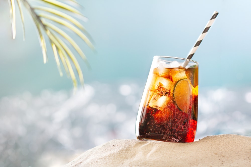 Refreshing Long Island Cocktail With Ice Cola And Lime On beach