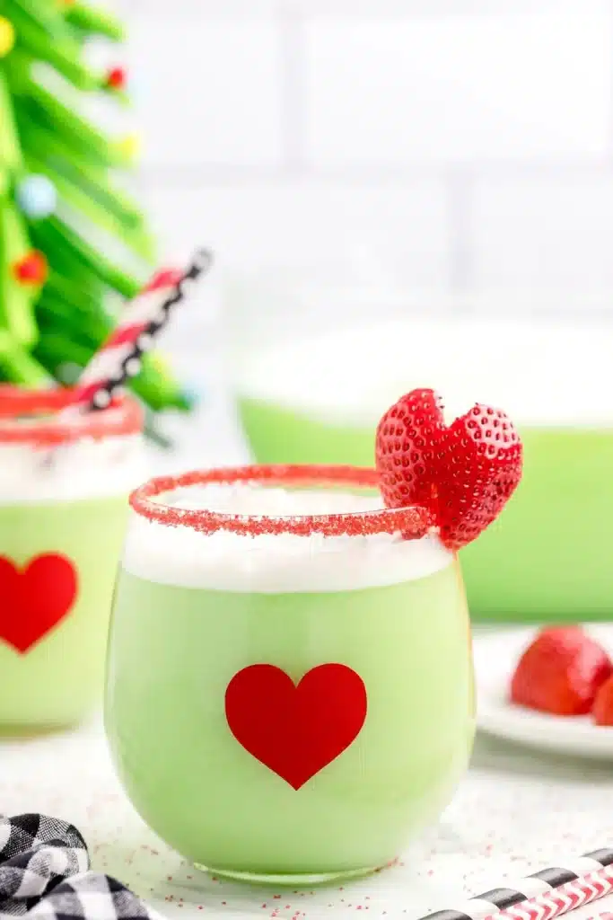 a glass of Tropical Twist Grinch garnished with a strawberry