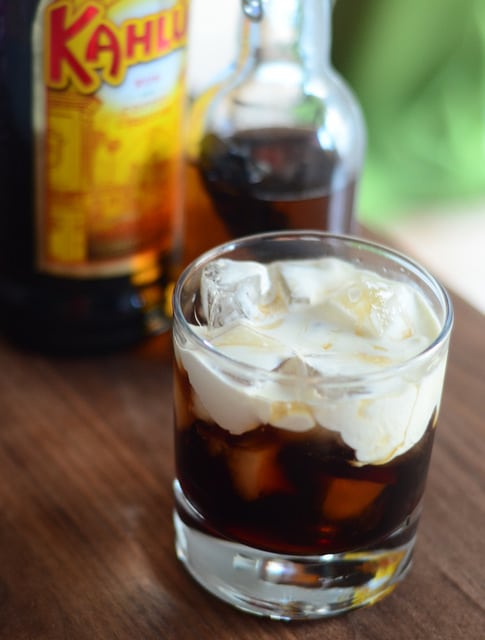 a glass of vanilla white russian with cream on top