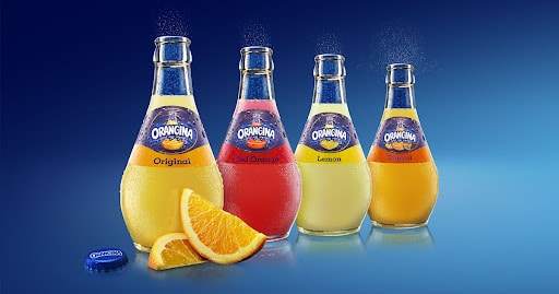 different flavor bottles of orangina drinks