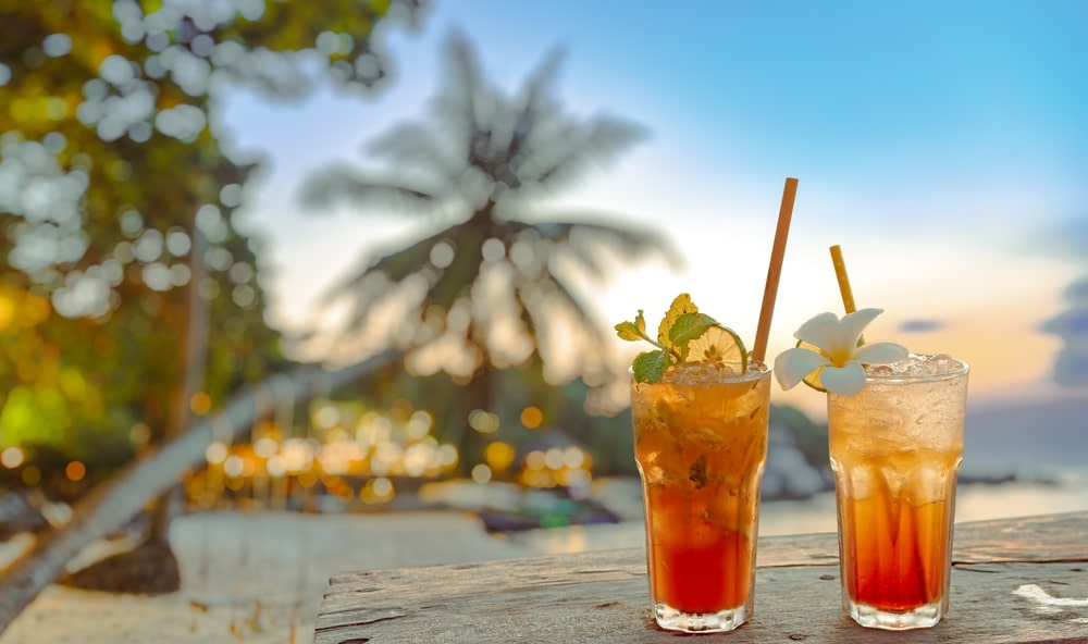 Drinks With Blur Beach And Sunset In Background