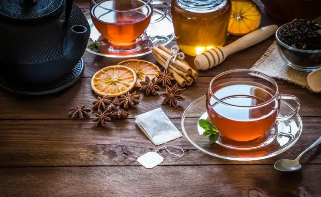 green tea in different cups and served with different herbs as garnish