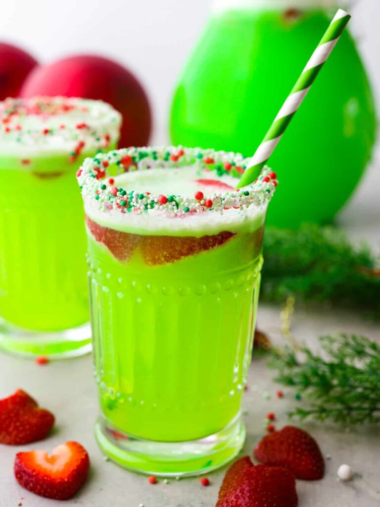 grich drink served in sprinkled rimmed glasses with a straw and strawberry slices