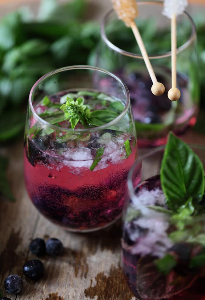 three glass of Berry and Basil Vodka Tonic with leavces for garnish