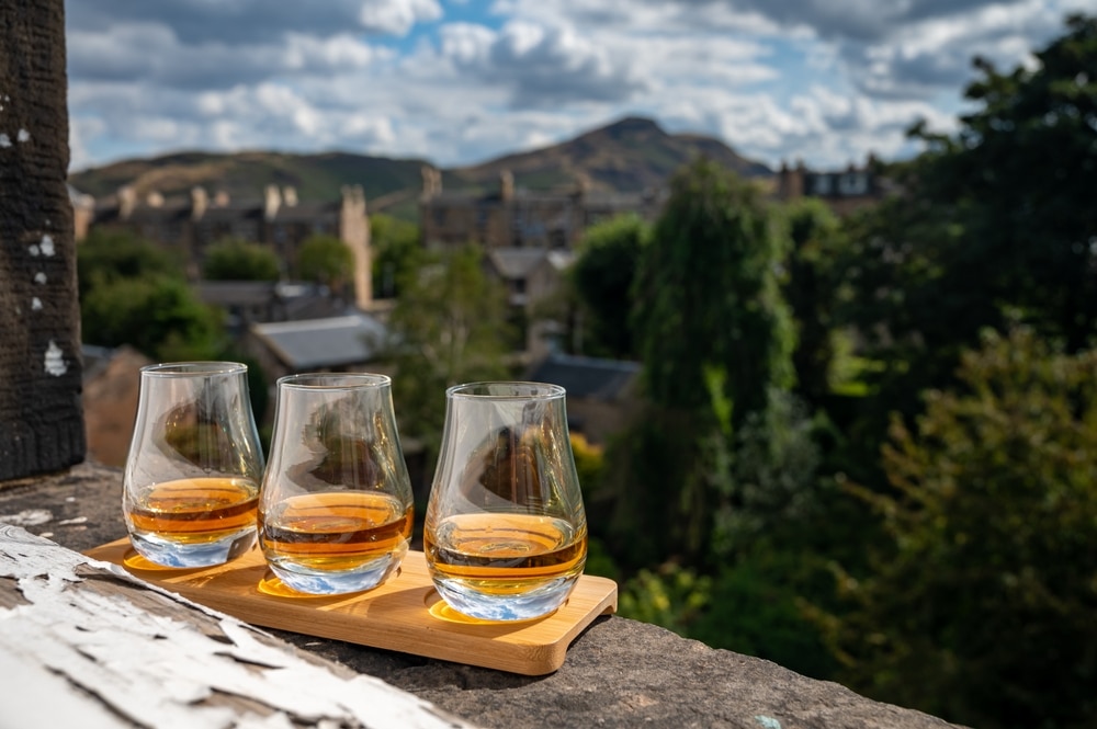 Flight Of Single Malt Scotch Whisky Served On Old Window