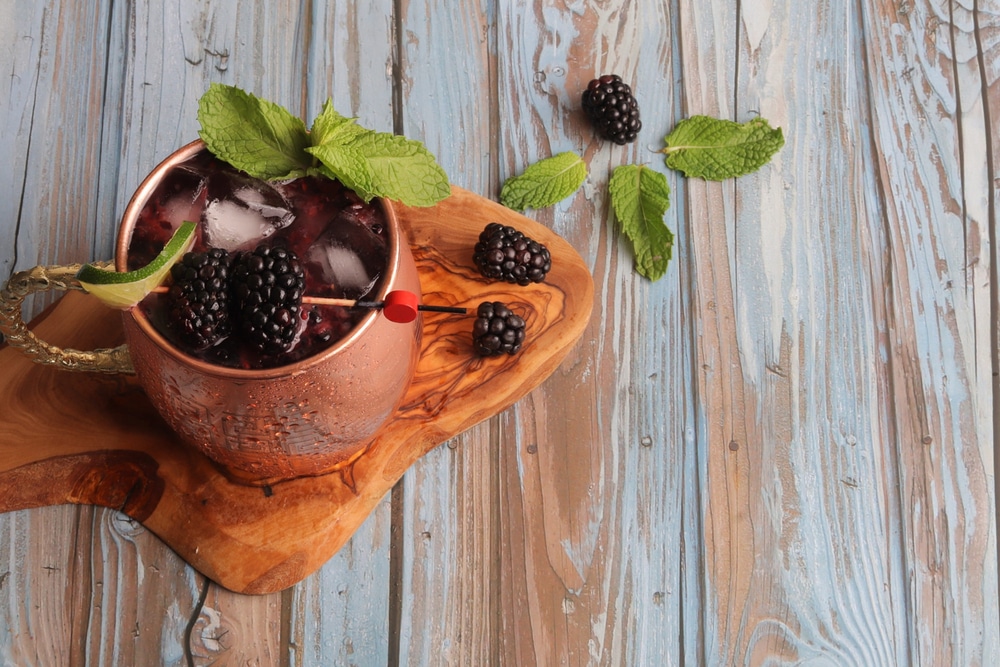 A top view of a mule drink with blueberries in a cup