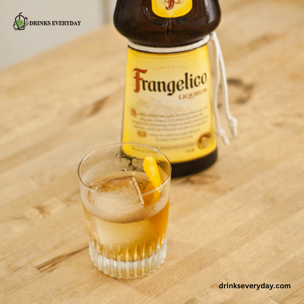 A view of a Frangelico drink inside a glass with a bottle