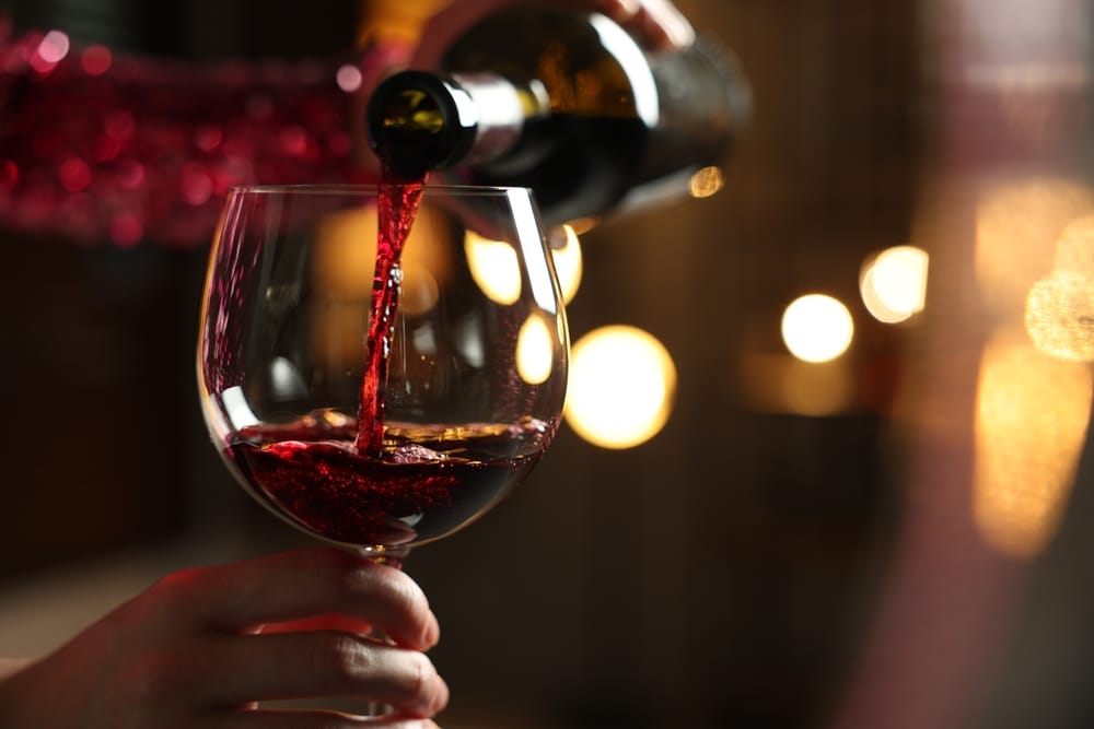 A view of a red wine being poured into a glass