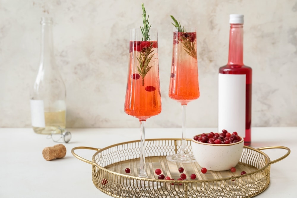 A view of two glasses of cranberry champagne drink