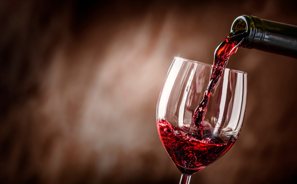 A view of red wine being poured from a bottle