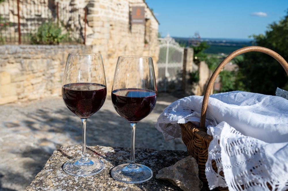 A view of two glasses of red wine outdoors