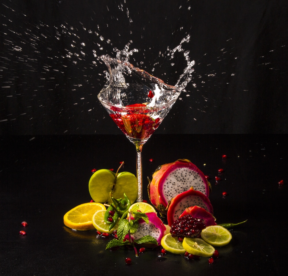 A view of a splash inside a martini glass filled with dragon fruit lemonade